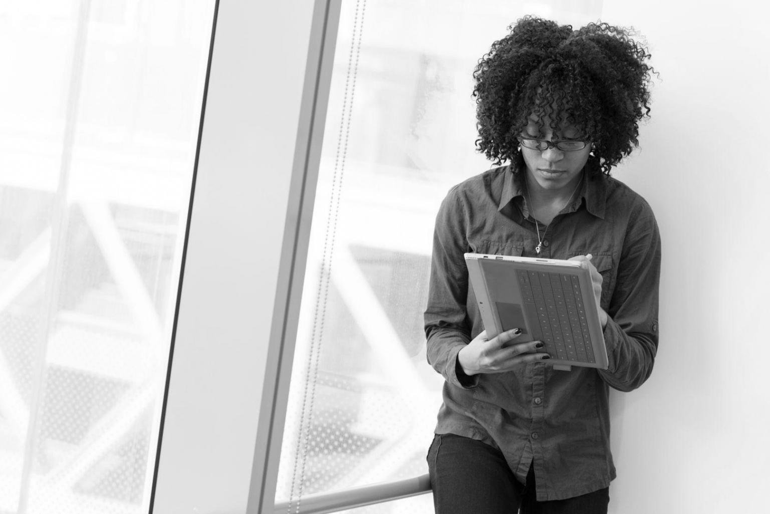 Students collaborating on budget analysis worksheets in modern learning environment